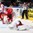 MINSK, BELARUS - MAY 11: Switzerland's Kevin Fiala #13 crashes into the goal as Belarus' Vitali Koval #1 gets knocked down on the play as Roman Graborenko #92 and Dmitri Korobov #89 look on during preliminary round action at the 2014 IIHF Ice Hockey World Championship. (Photo by Andre Ringuette/HHOF-IIHF Images)

